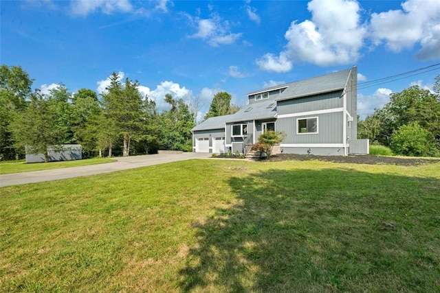 view of front of house with a front yard and a garage