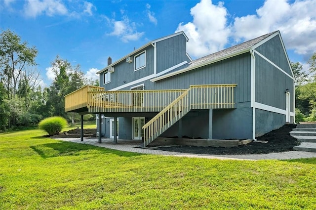 rear view of property featuring a yard and a wooden deck