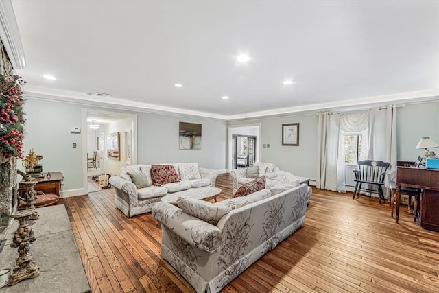 living room featuring light hardwood / wood-style flooring and crown molding