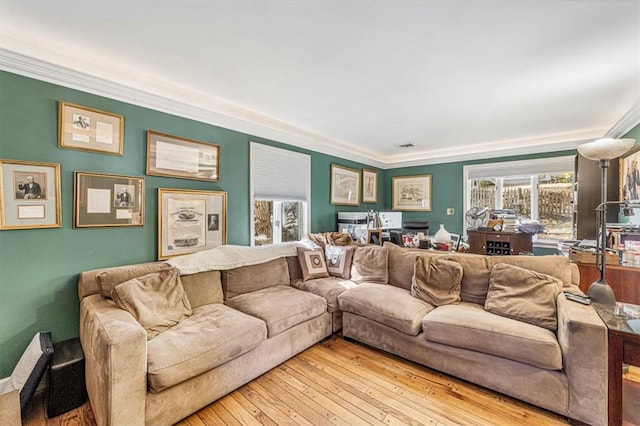 living room with light hardwood / wood-style flooring and crown molding