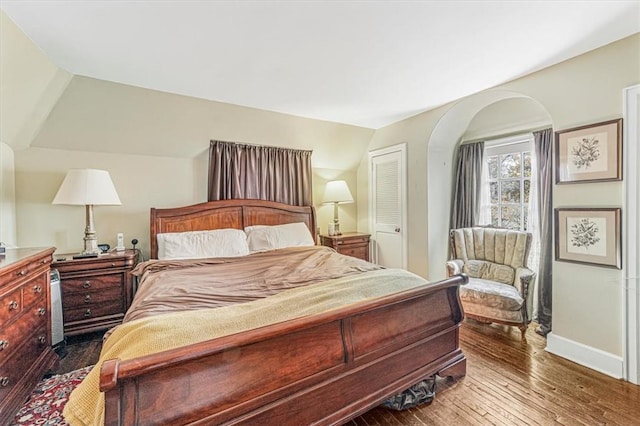 bedroom featuring a closet, lofted ceiling, and hardwood / wood-style flooring