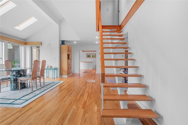 94 Overlook Dr, Andes, NY 13731 - staircase featuring wood-type flooring, high vaulted ceiling, and a skylight