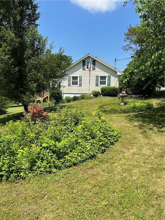 view of property exterior with a yard