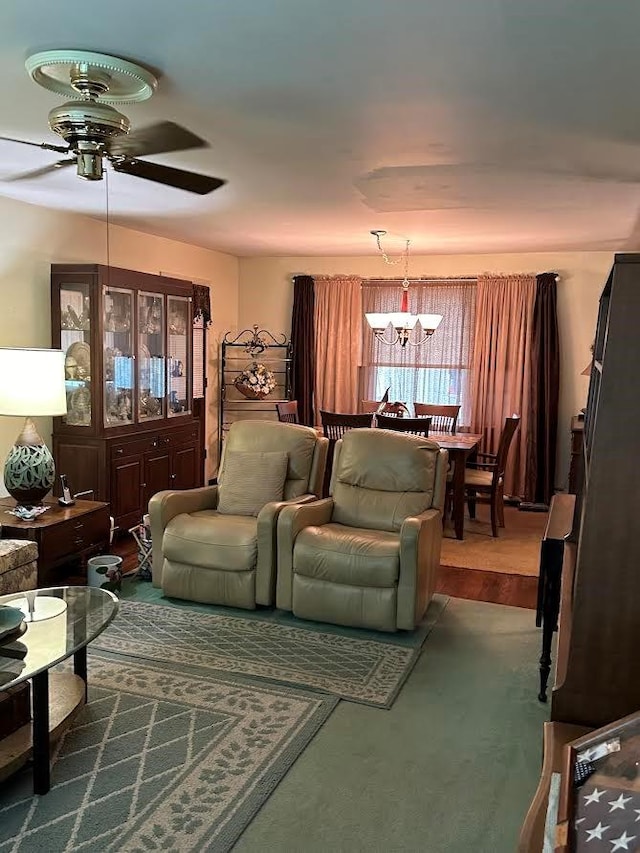 interior space with carpet flooring and ceiling fan with notable chandelier