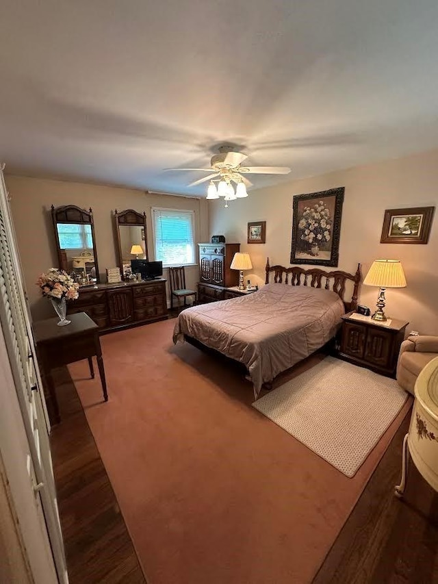 bedroom with hardwood / wood-style floors and ceiling fan