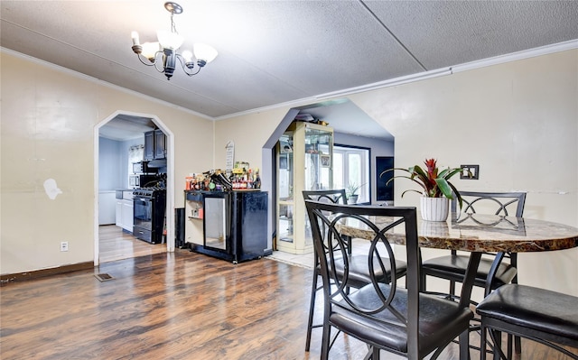 2424 State Route 17k, Montgomery, NY 12549 - dining space featuring crown molding, wood finished floors, a chandelier, a textured ceiling, and arched walkways