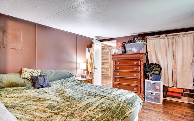 2424 State Route 17k, Montgomery, NY 12549 - bedroom featuring wood finished floors, wooden walls, and a textured ceiling