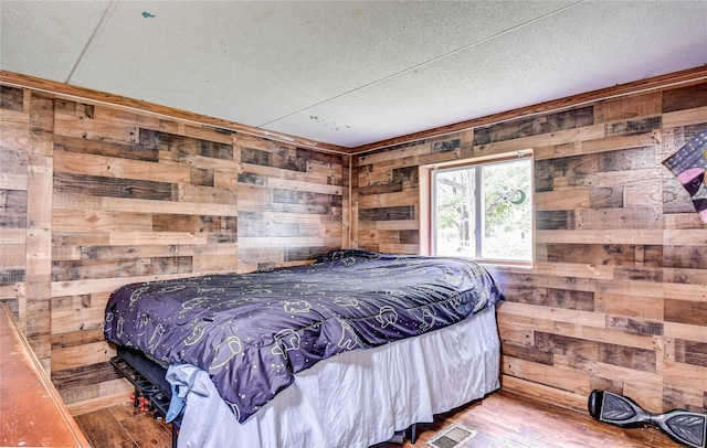 2424 State Route 17k, Montgomery, NY 12549 - bedroom with wooden walls, wood finished floors, and a textured ceiling