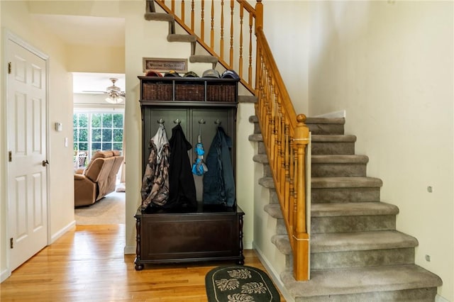 mudroom with ceiling fan and light hardwood / wood-style flooring