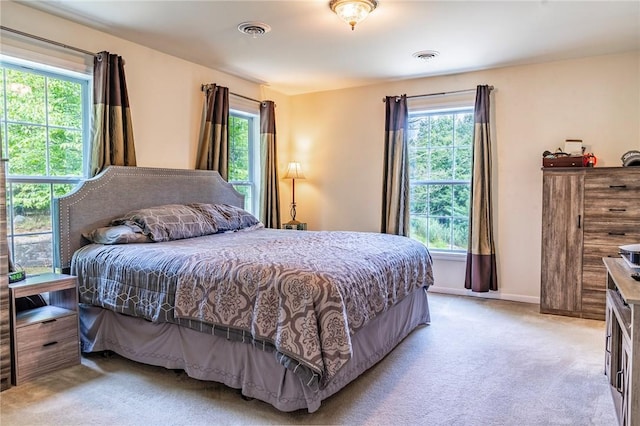 carpeted bedroom featuring multiple windows