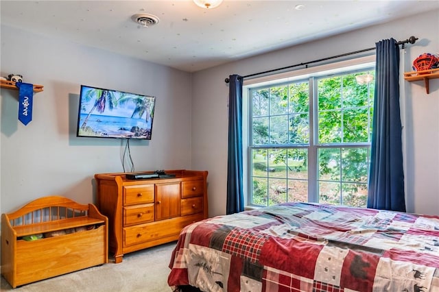 bedroom featuring light carpet