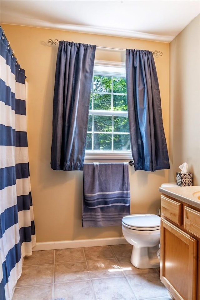 bathroom with a shower with curtain, tile patterned flooring, vanity, and toilet