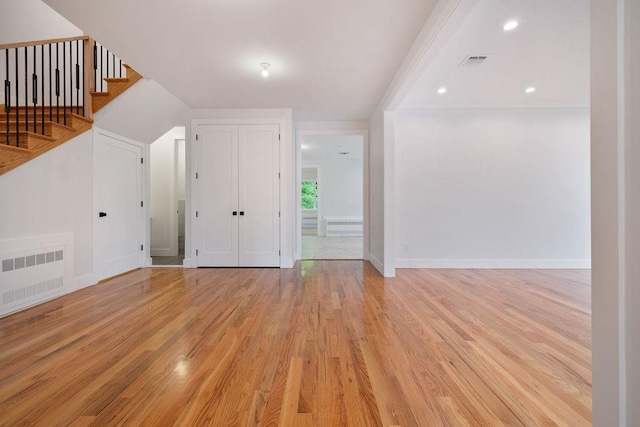 23 Northbrook Rd Unit 202, Spring Valley, NY 10977 - unfurnished living room with light wood finished floors, baseboards, and stairway
