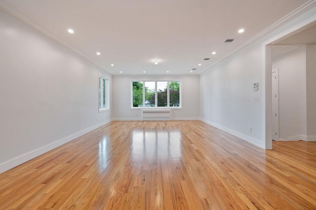 23 Northbrook Rd Unit 202, Spring Valley, NY 10977 - unfurnished room featuring radiator heating unit, ornamental molding, light wood finished floors, baseboards, and recessed lighting