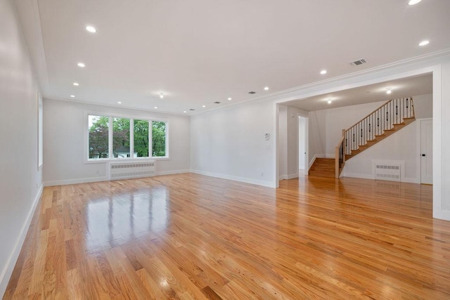 23 Northbrook Rd Unit 202, Spring Valley, NY 10977 - unfurnished room with radiator, light wood-type flooring, stairs, baseboards, and ornamental molding