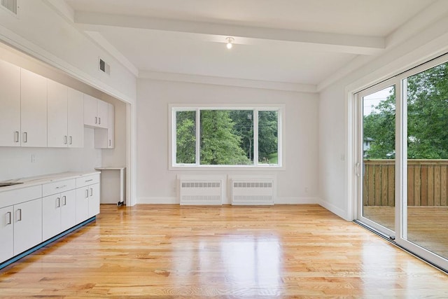 23 Northbrook Rd Unit 202, Spring Valley, NY 10977 - kitchen with radiator heating unit, plenty of natural light, beamed ceiling, and light wood-style flooring