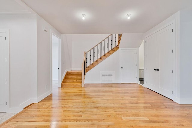 23 Northbrook Rd Unit 202, Spring Valley, NY 10977 - unfurnished living room featuring light wood finished floors, stairs, and baseboards