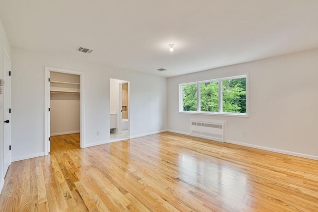 23 Northbrook Rd Unit 202, Spring Valley, NY 10977 - empty room featuring radiator, light wood finished floors, and baseboards