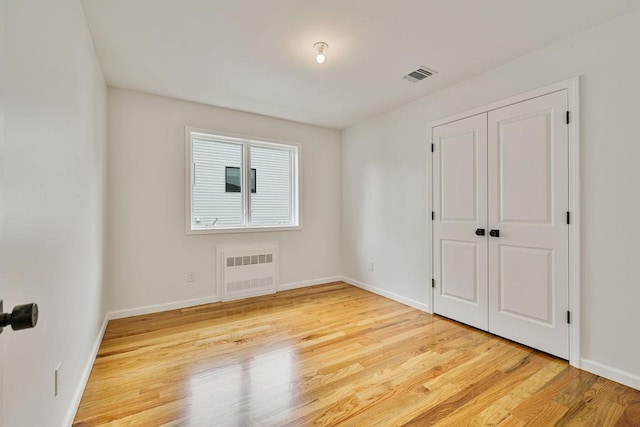 23 Northbrook Rd Unit 202, Spring Valley, NY 10977 - unfurnished bedroom with radiator, wood finished floors, and baseboards