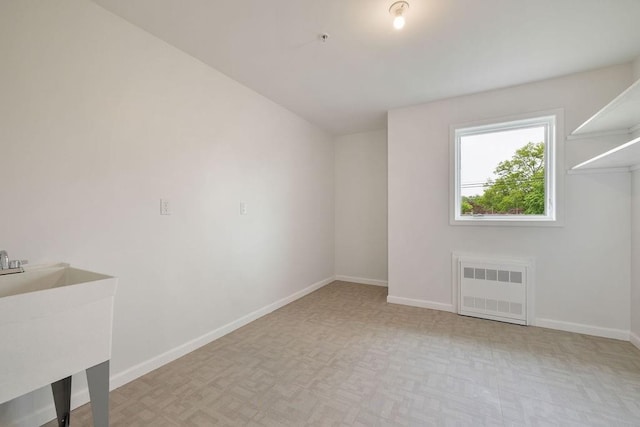 23 Northbrook Rd Unit 202, Spring Valley, NY 10977 - unfurnished living room with radiator heating unit, baseboards, and a sink