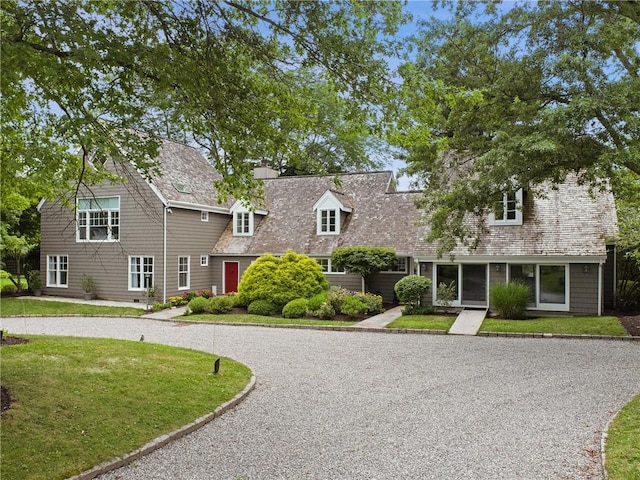 new england style home with a front yard