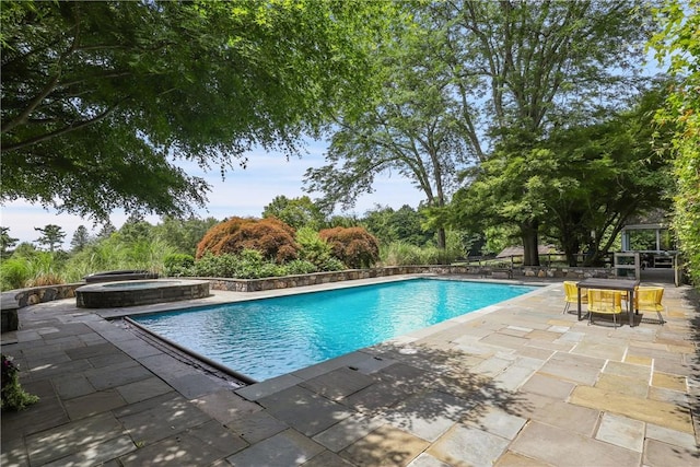 view of pool featuring an in ground hot tub and a patio