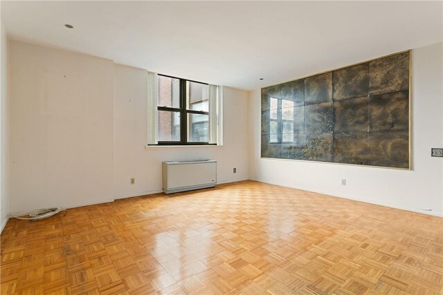23 Water Grant St Unit 6K, Yonkers, NY 10701 - empty room featuring baseboards and radiator heating unit