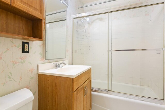 23 Water Grant St Unit 6K, Yonkers, NY 10701 - full bath featuring vanity, toilet, combined bath / shower with glass door, and wallpapered walls