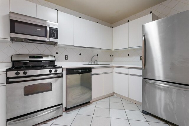23 Water Grant St Unit 6K, Yonkers, NY 10701 - kitchen with appliances with stainless steel finishes, light countertops, a sink, and decorative backsplash