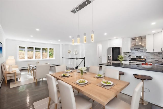 dining space with baseboard heating and dark hardwood / wood-style flooring