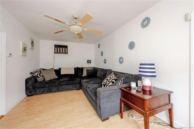 living room featuring ceiling fan and light hardwood / wood-style floors