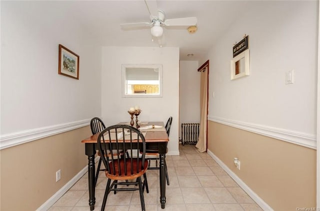 dining room featuring radiator and ceiling fan