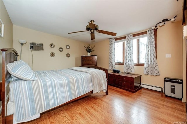 bedroom featuring light hardwood / wood-style floors, a wall mounted AC, ceiling fan, and baseboard heating