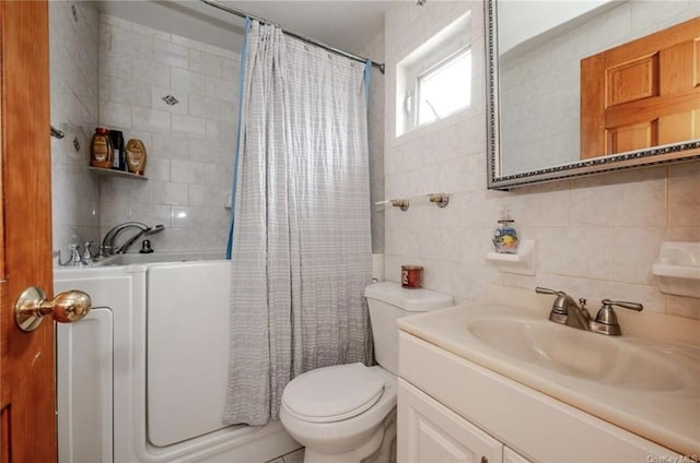 full bathroom with tile walls, backsplash, vanity, and toilet