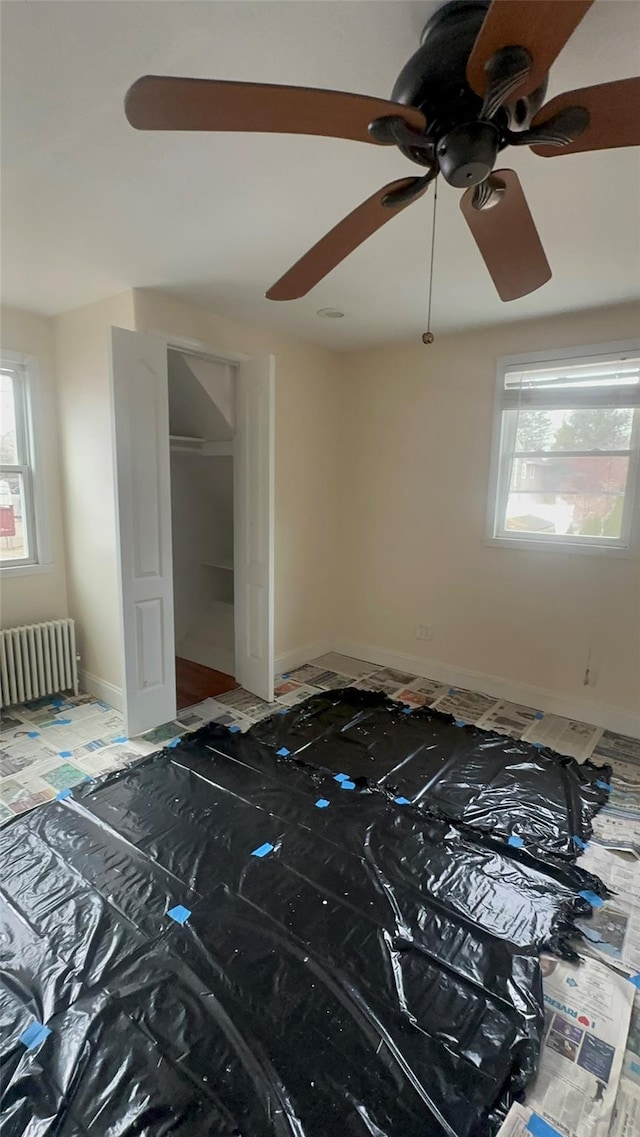 interior space featuring radiator and ceiling fan