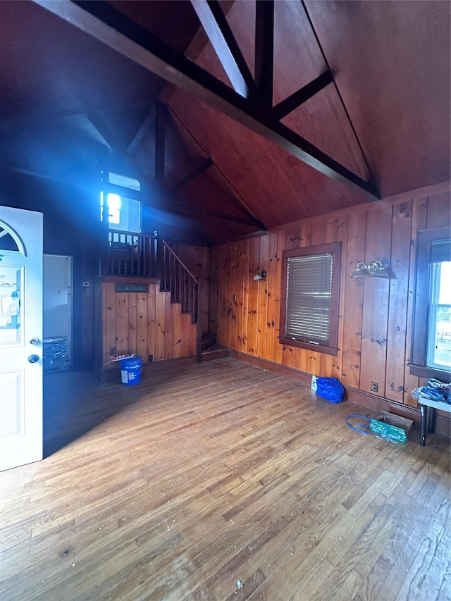 interior space featuring wood walls, wooden ceiling, hardwood / wood-style flooring, and lofted ceiling