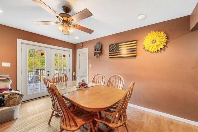 dining space with ceiling fan, light wood-type flooring, and french doors