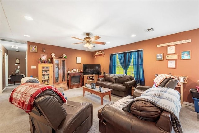 carpeted living room featuring ceiling fan