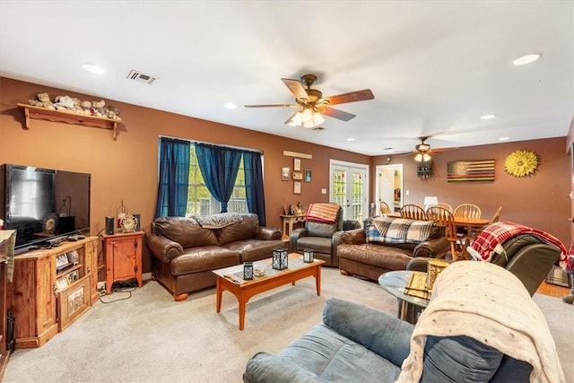 carpeted living room featuring ceiling fan