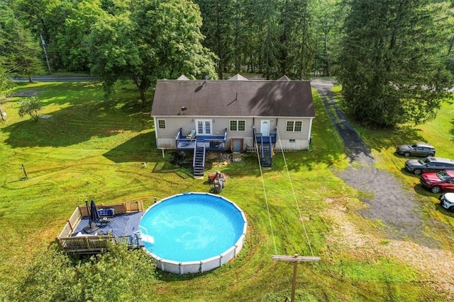 view of pool with a yard and a wooden deck