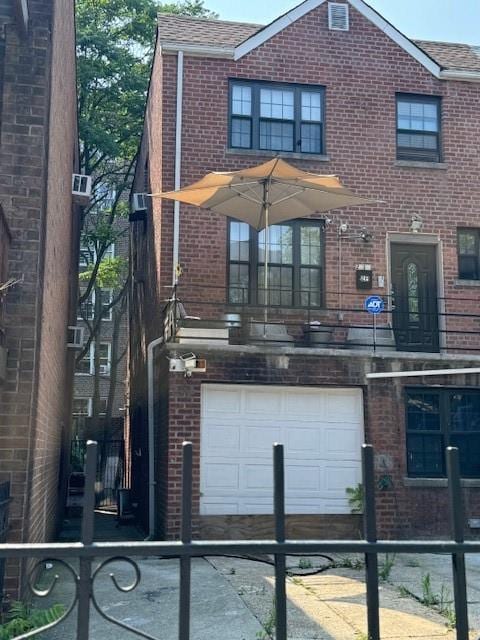 view of front of home featuring a balcony and a garage