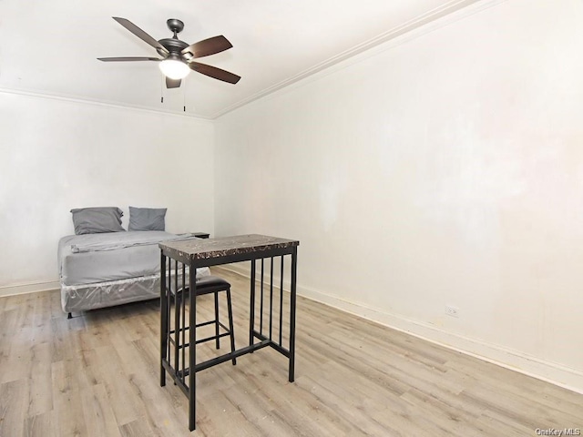 bedroom featuring ceiling fan, light hardwood / wood-style floors, and crown molding