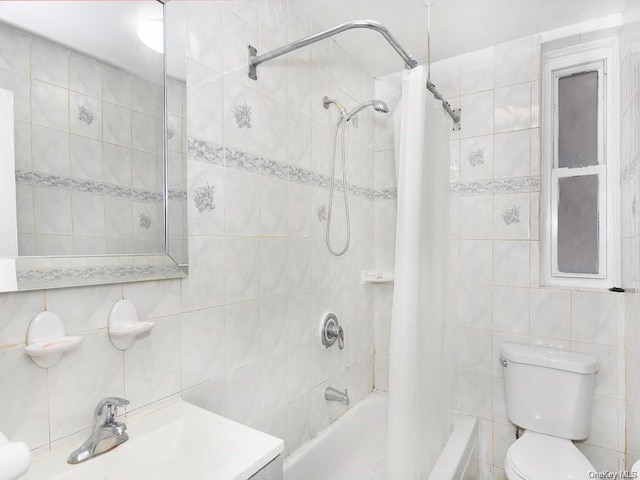 full bathroom with vanity, toilet, tile walls, and shower / tub combo