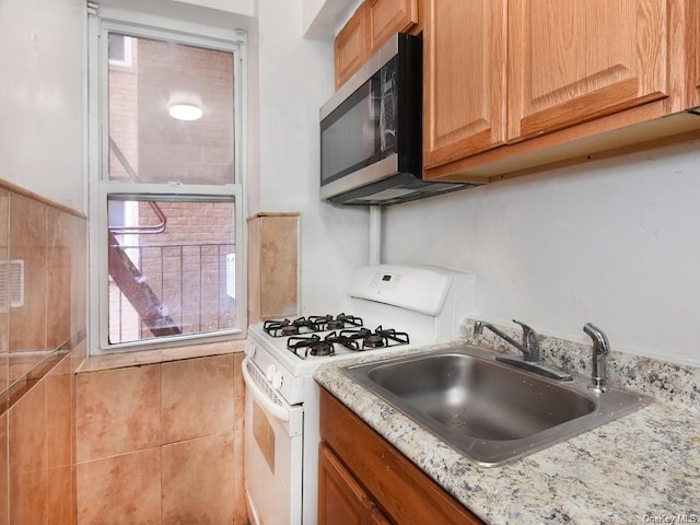 2191 Bolton St Unit 3E, Bronx, NY 10462 - kitchen with gas range gas stove, stainless steel microwave, and light stone counters