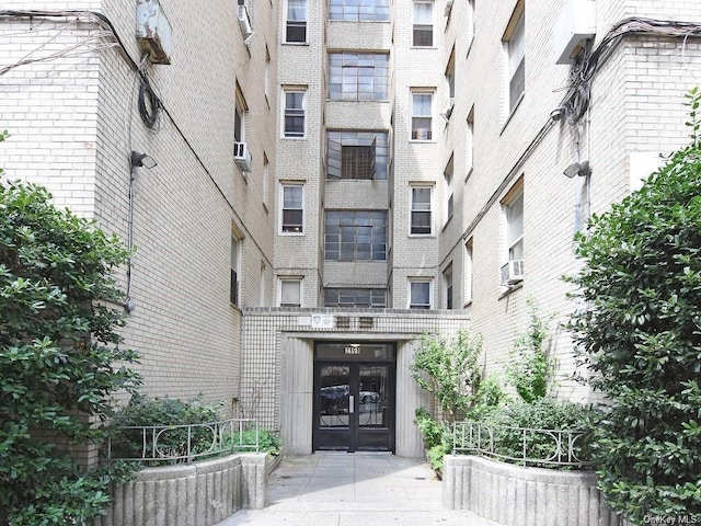 2191 Bolton St Unit 3E, Bronx, NY 10462 - property entrance with french doors, brick siding, and cooling unit