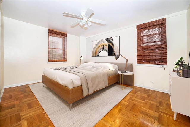 bedroom featuring ceiling fan and parquet flooring