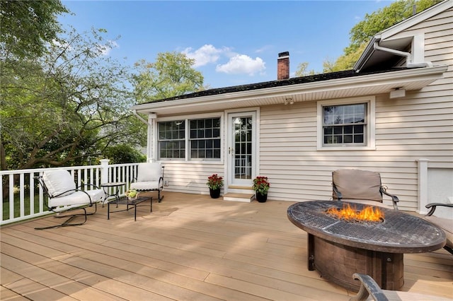 wooden terrace featuring an outdoor fire pit