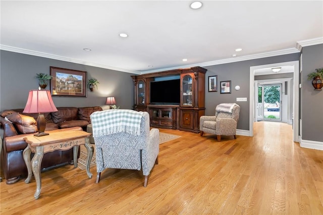 living room with light hardwood / wood-style flooring and crown molding