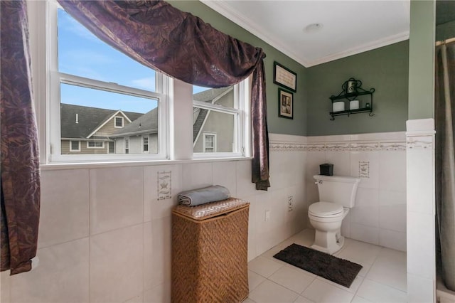 bathroom featuring toilet, tile patterned flooring, tile walls, and ornamental molding