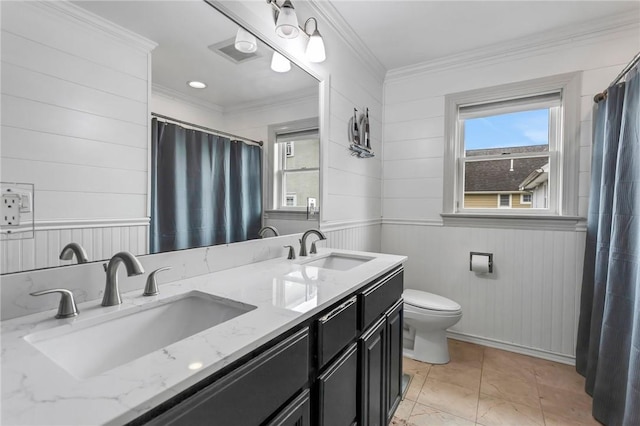 bathroom with vanity, toilet, crown molding, and wooden walls